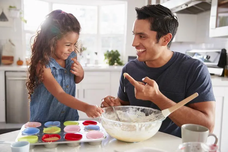 Father baking with daughter